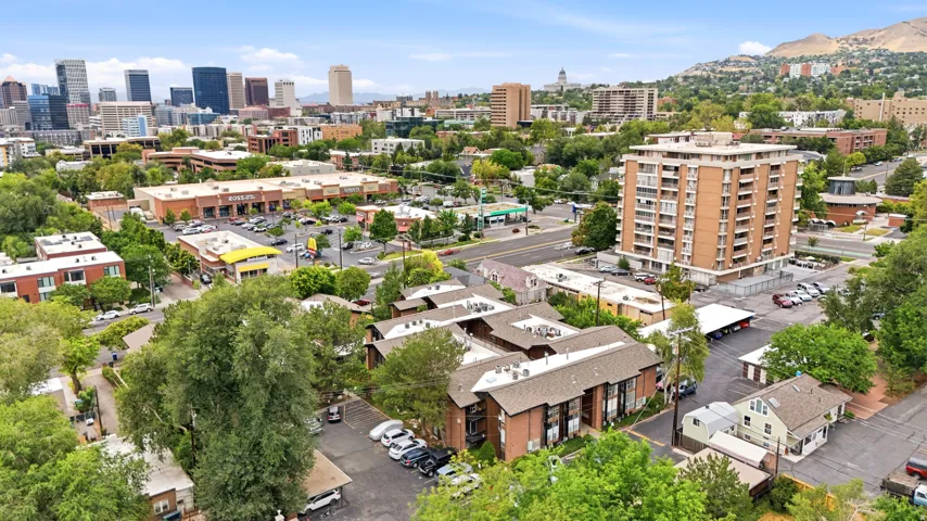 Urban setting featuring diverse architectural styles, mature tree cover, a prominent high-rise building. Close to downtown!