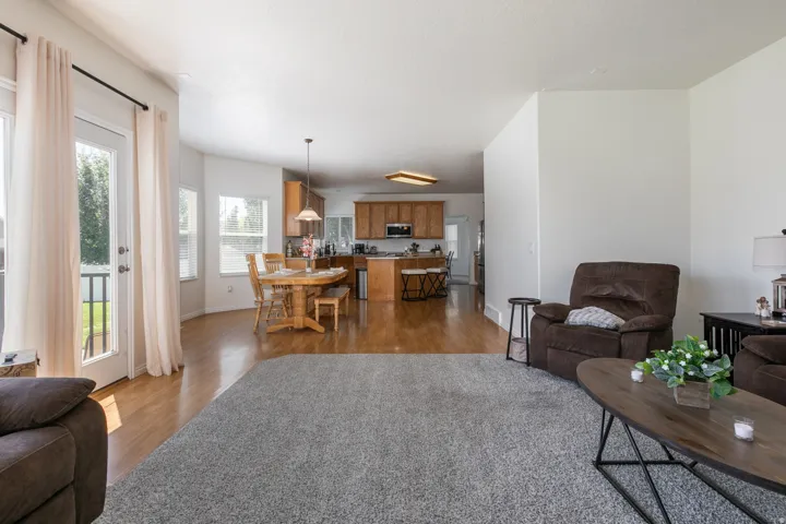 Expansive living area featuring carpeted flooring and light-toned walls
