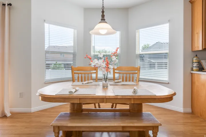 Bay window dining area with wood-finish flooring