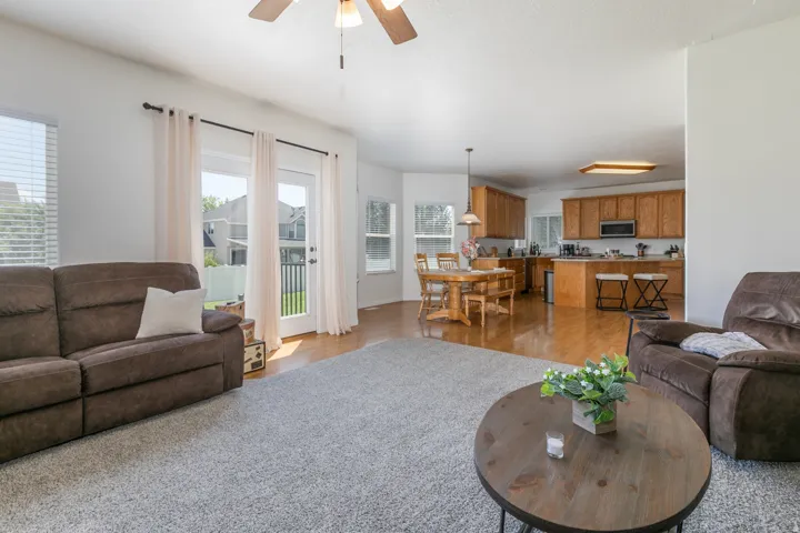Open-concept living space featuring light wood-finish flooring in the kitchen and dining areas