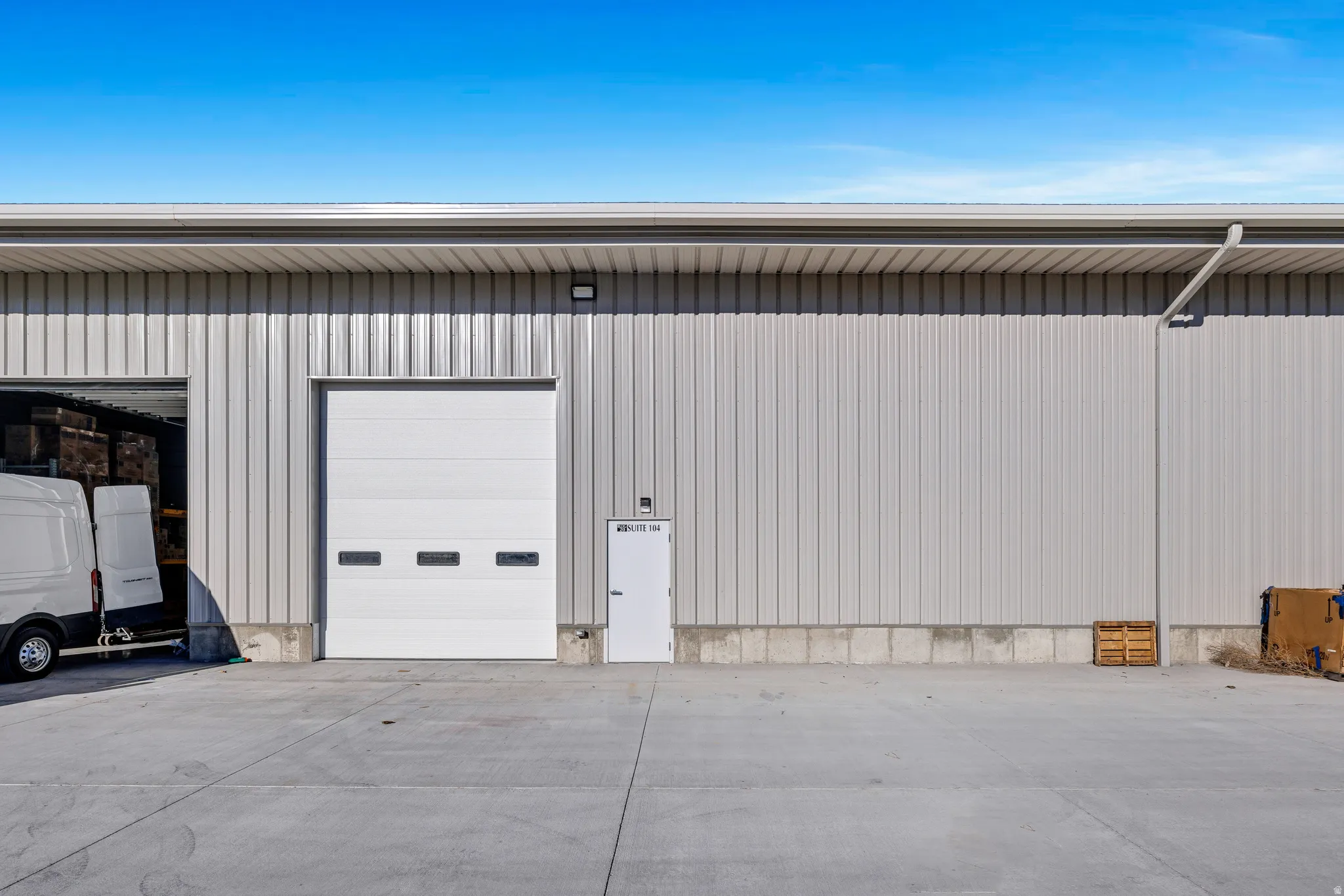 Commercial building featuring corrugated metal siding and a concrete foundation