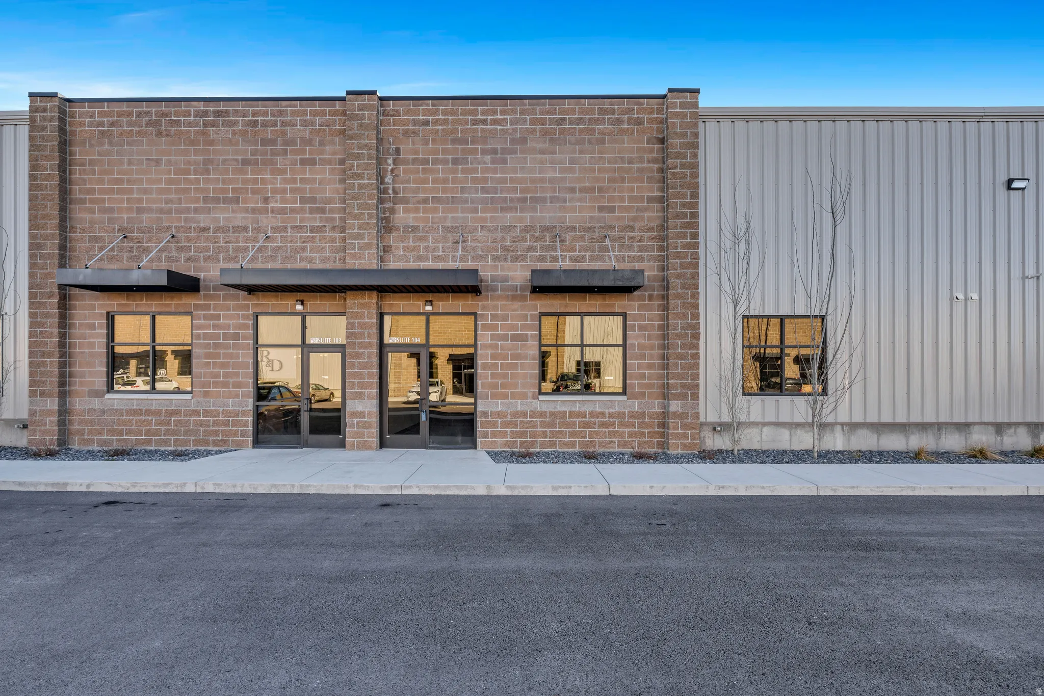 Commercial building featuring a brick facade and corrugated metal siding