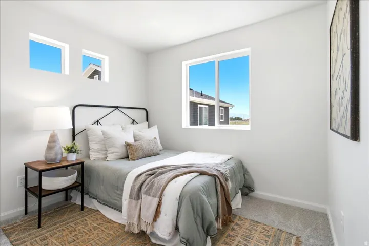 Carpeted bedroom with a large window and two smaller transom windows