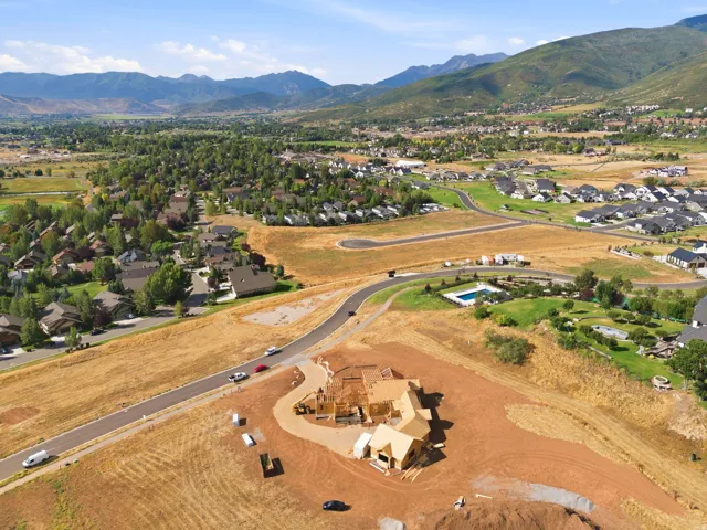 Mountainous terrain, residential developments, an in-ground swimming pool, and roads