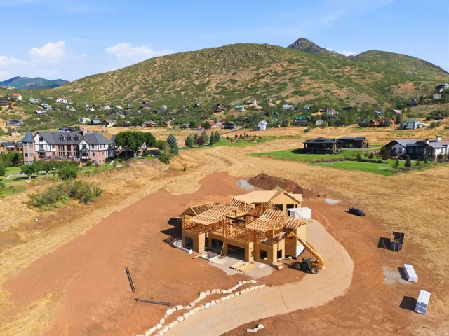New construction framing with surrounding mountainous terrain