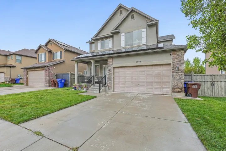 Contemporary exterior featuring stone facade accents and stucco siding