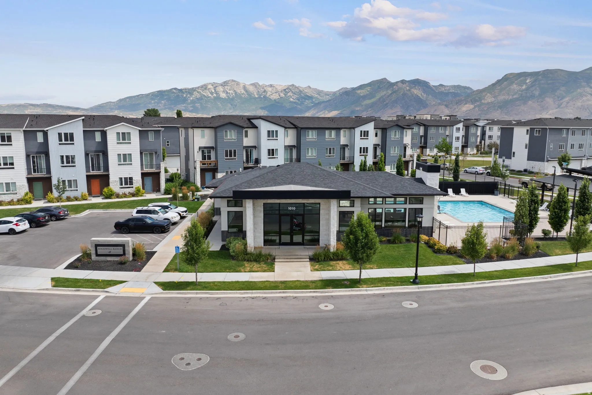 Contemporary community featuring a central clubhouse with a swimming pool