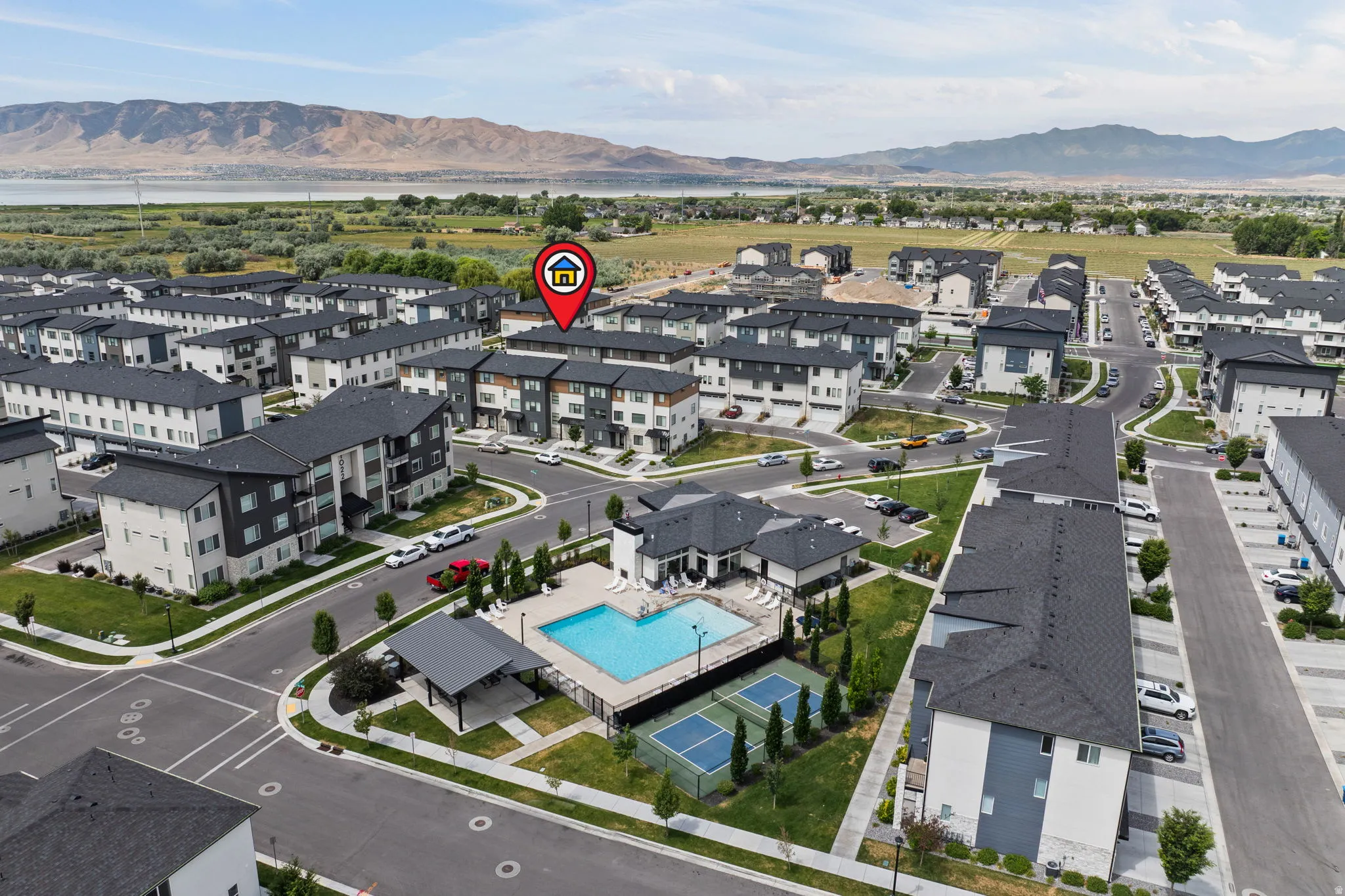 Community amenities featuring an outdoor swimming pool, two tennis courts, and a covered pavilion