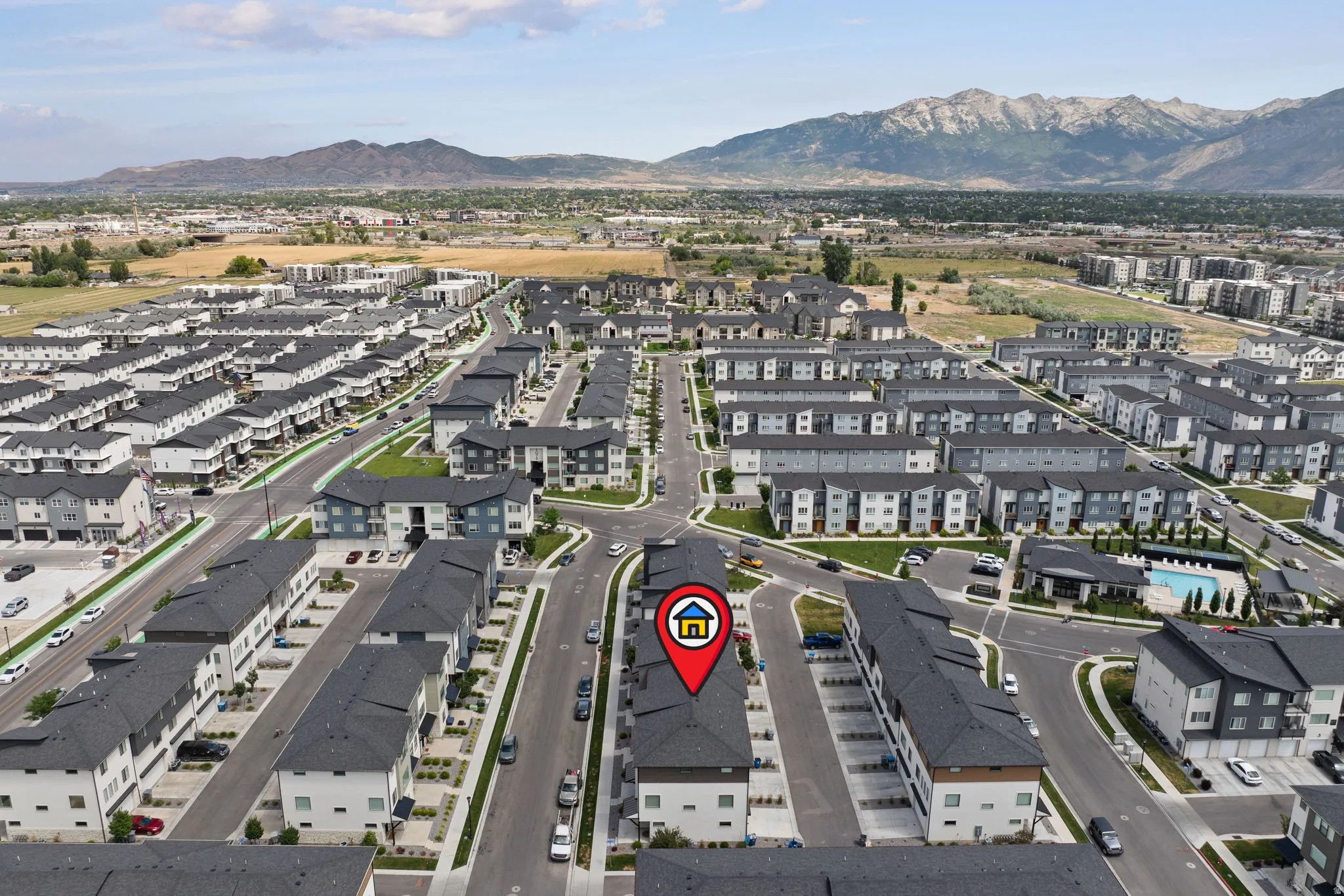 Modern multi-level townhome featuring a low-slope roof design, contemporary exterior finishes, and an attached garage