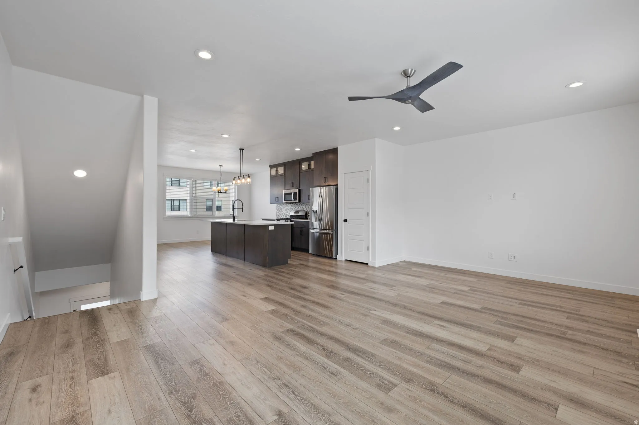 Spacious interior featuring wide-plank wood-finish flooring and recessed lighting