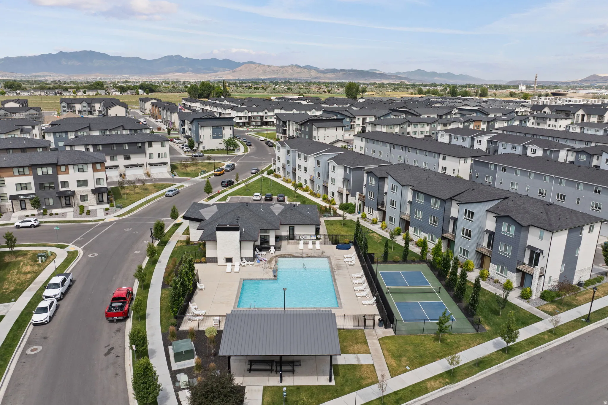 Community amenities featuring a swimming pool, clubhouse, and tennis courts