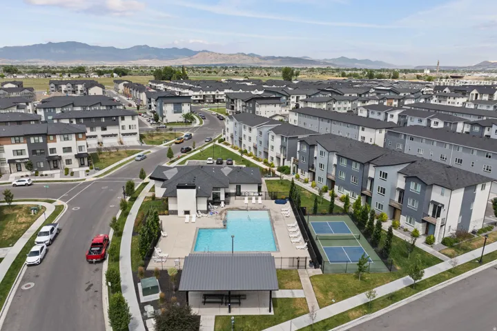 Community amenities featuring a swimming pool, clubhouse, and tennis courts