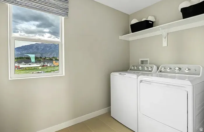Laundry area with a window providing a mountain backdrop
