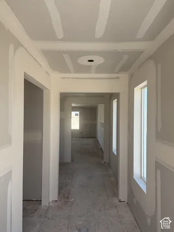 Recessed ceiling detail with central fixture provision, multiple window openings, and unfinished wall surfaces