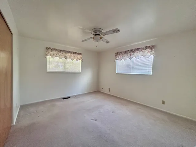 Primary bedroom with two corner windows