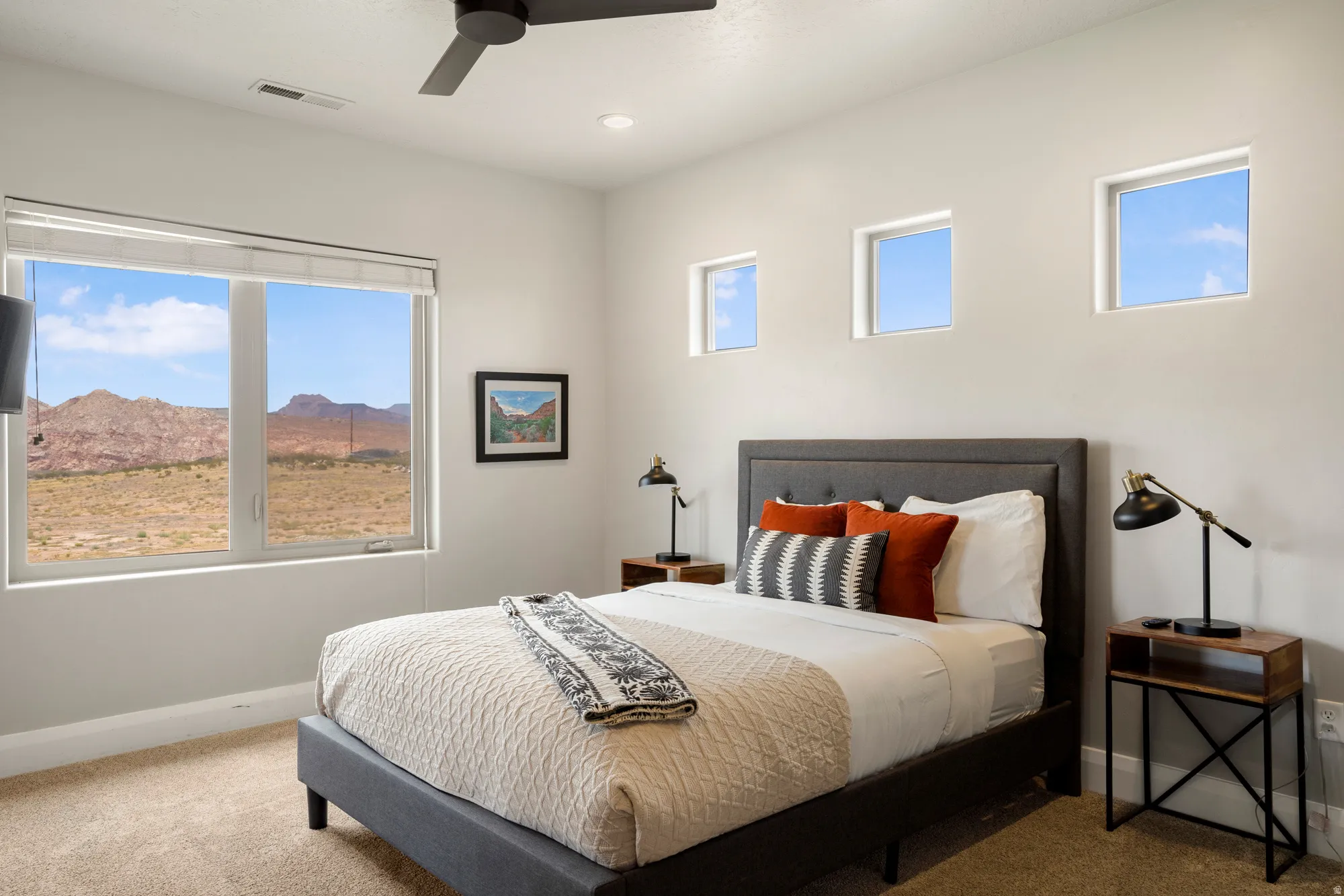 Neutral wall tones complement the light-colored carpet flooring
