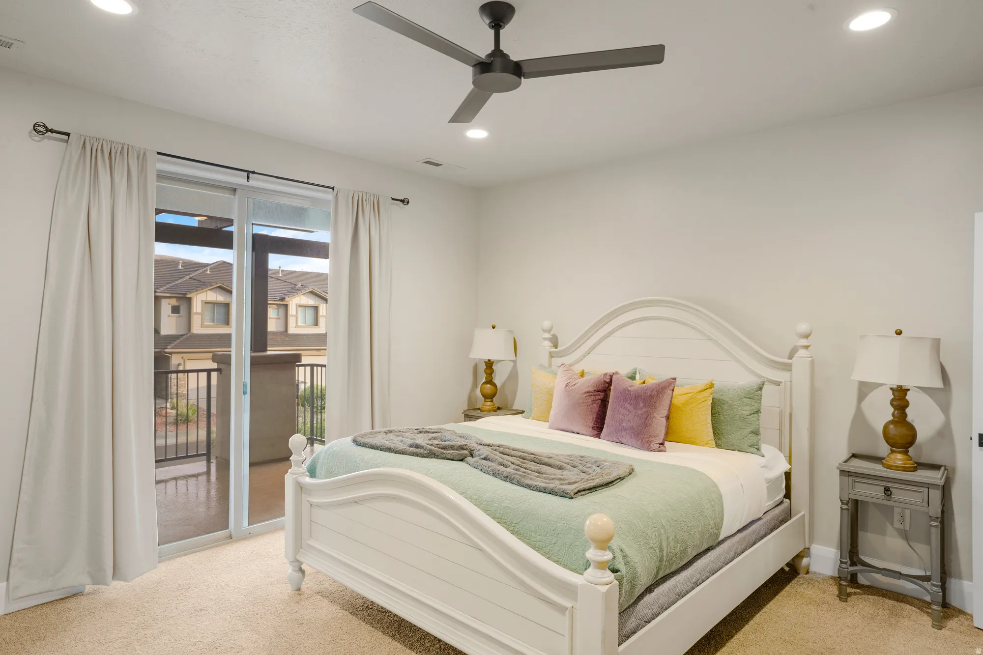 Bedroom featuring a sliding glass door to an exterior balcony, recessed lighting, and a ceiling fan