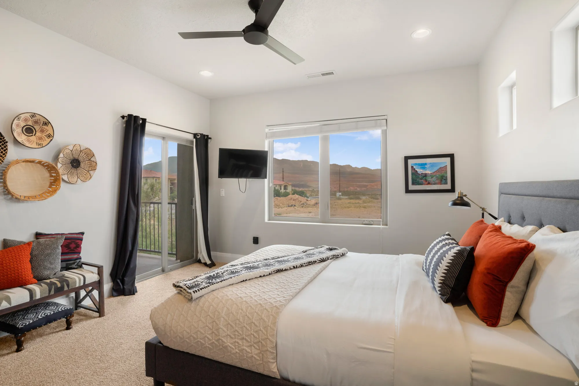 Bedroom featuring a sliding glass door to a balcony, a large window with mountain scenery, a black ceiling fan, and recessed lighting