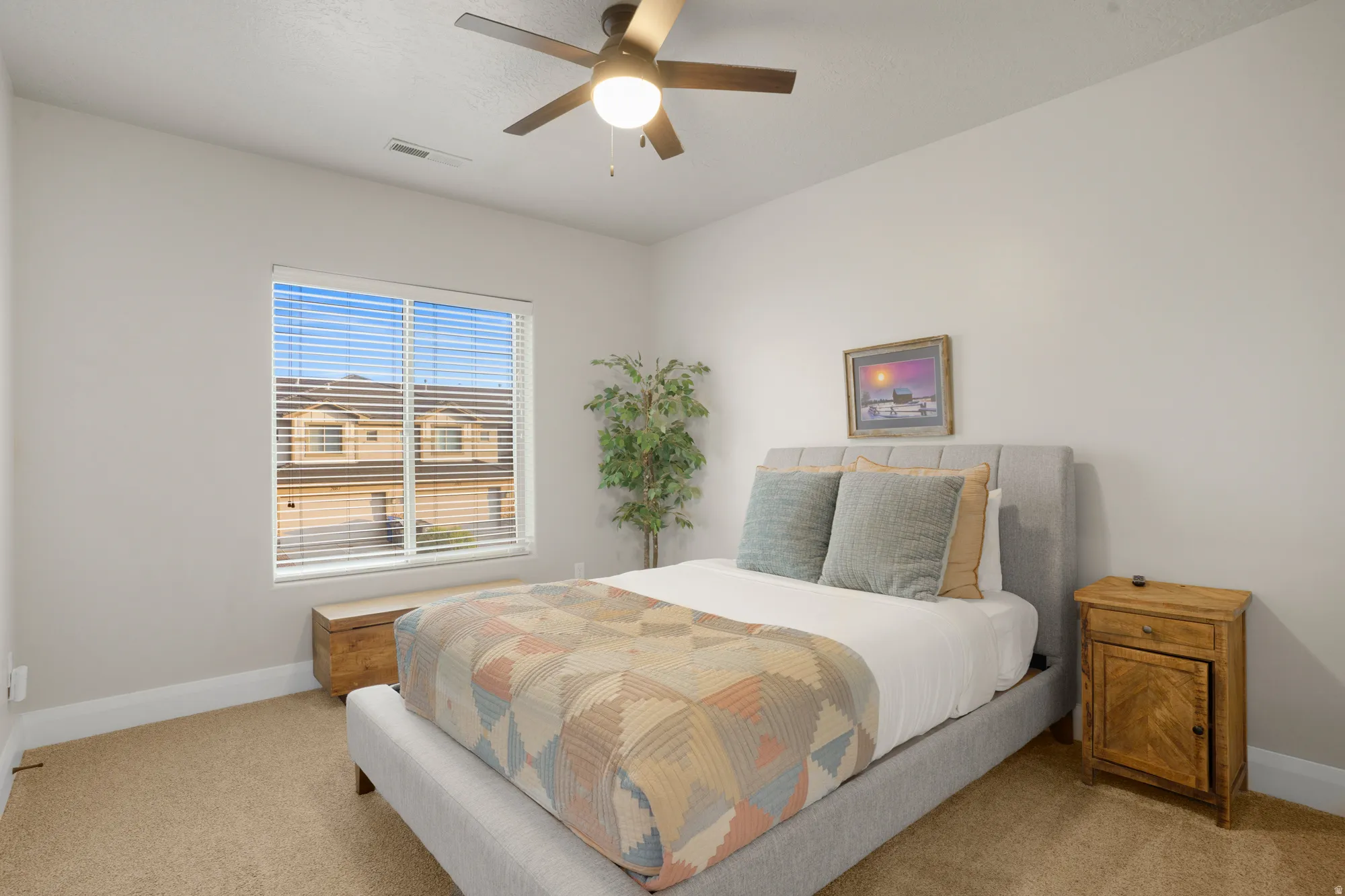 Bedroom featuring neutral wall paint, carpet flooring, a window with horizontal blinds, a ceiling fan with integrated lighting, and white baseboards
