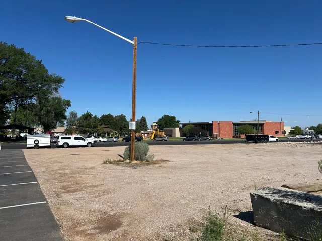Expansive gravel lot featuring an adjacent paved parking area