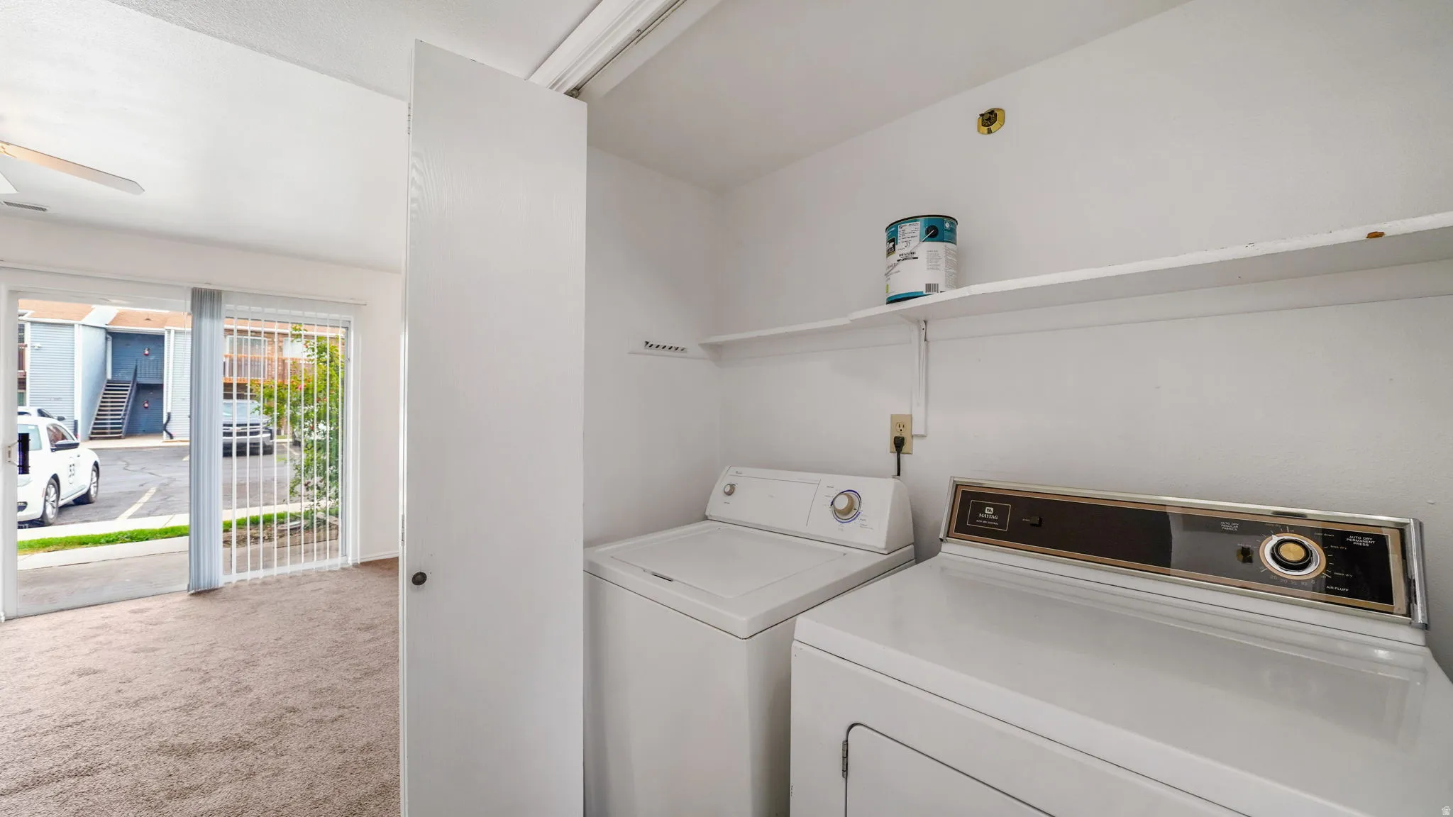 Dedicated laundry area with upper shelving.  Washer/Dryer included.
