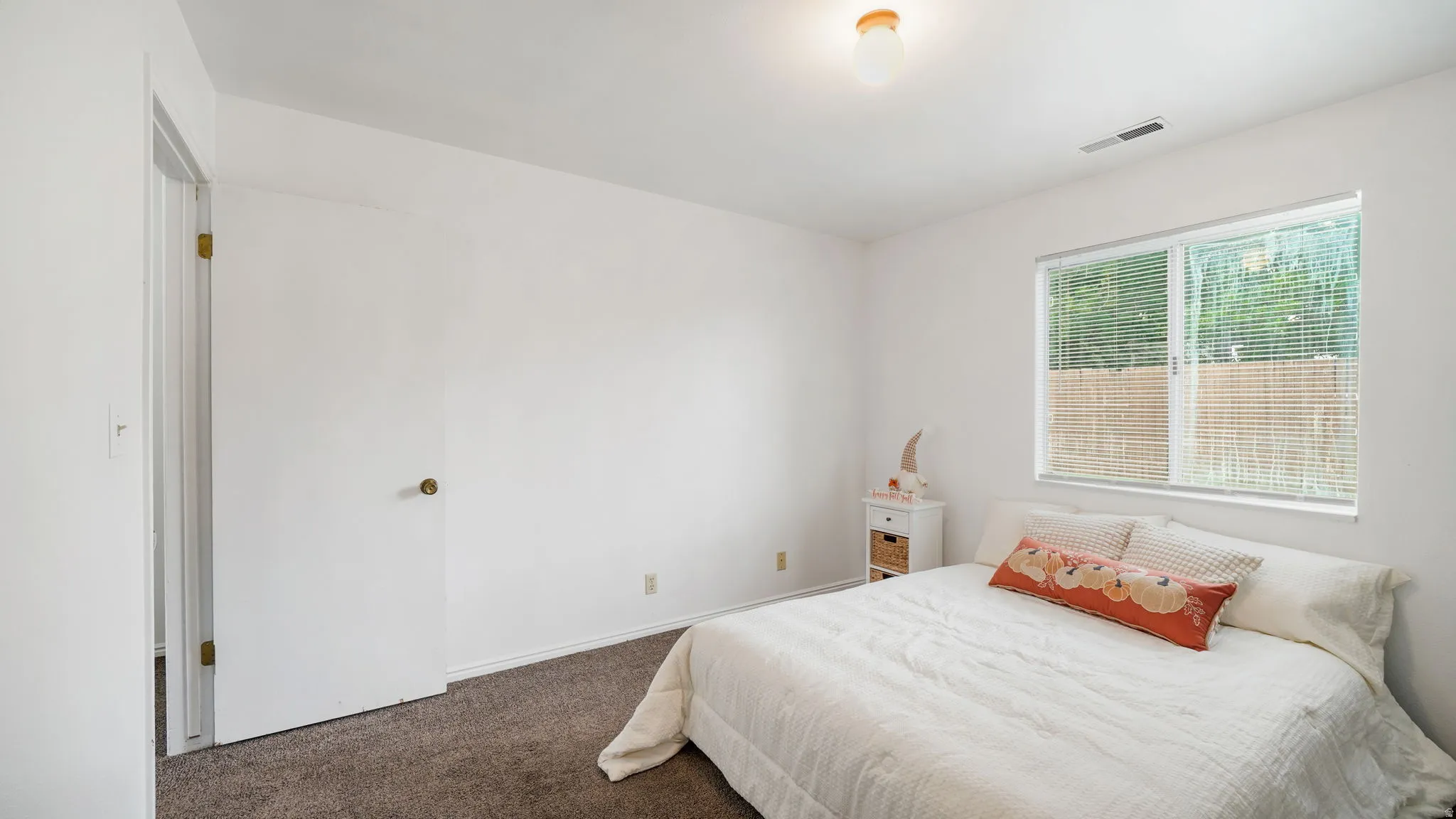 Bedroom #2:  Room featuring a window with blinds, light-colored walls, and carpeted flooring