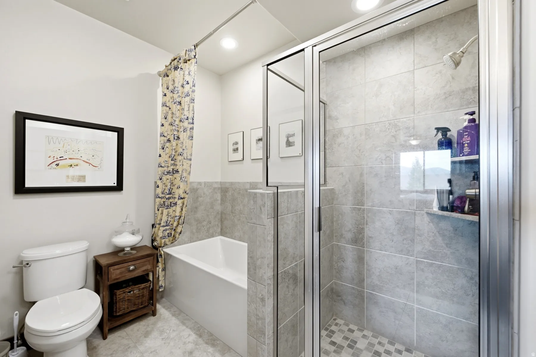 Bathroom featuring a glass-enclosed shower with full-height tile surround and mosaic tile flooring