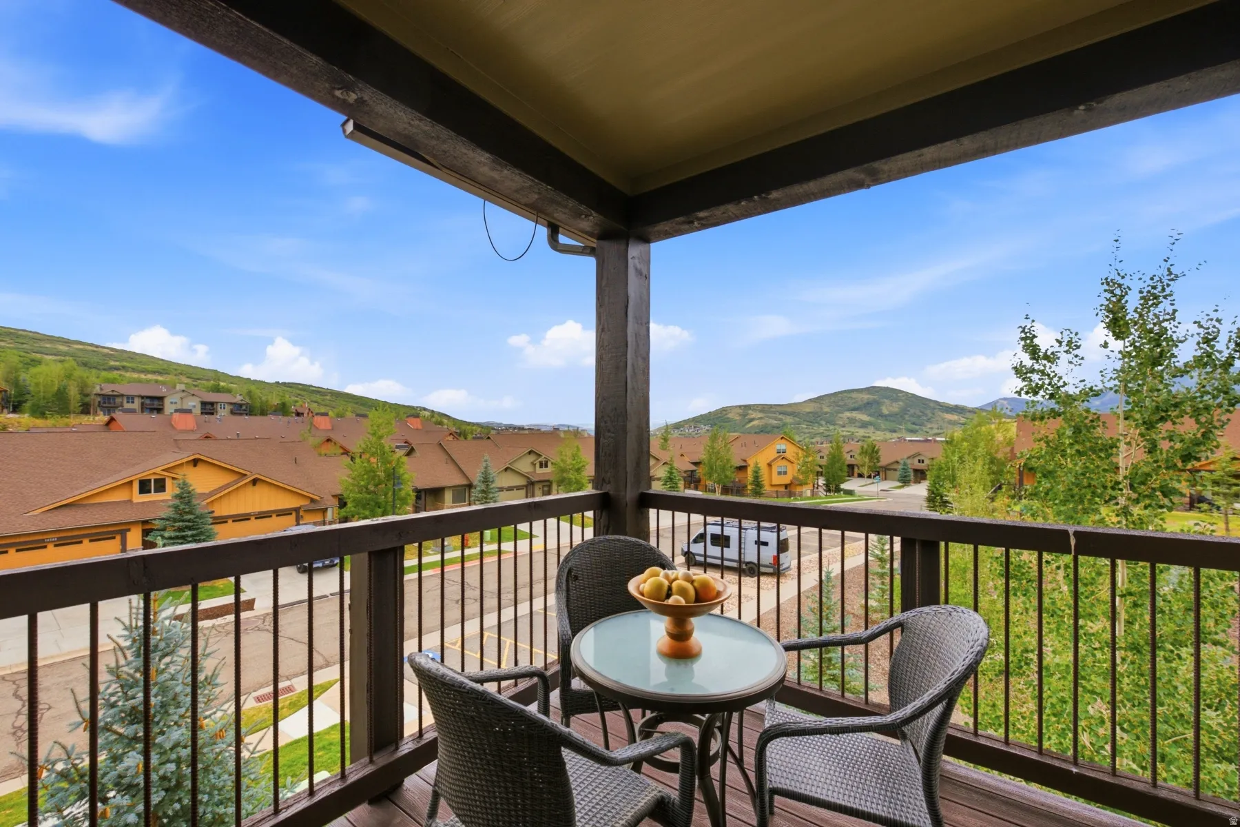 Private balcony featuring wood-finish flooring and railing