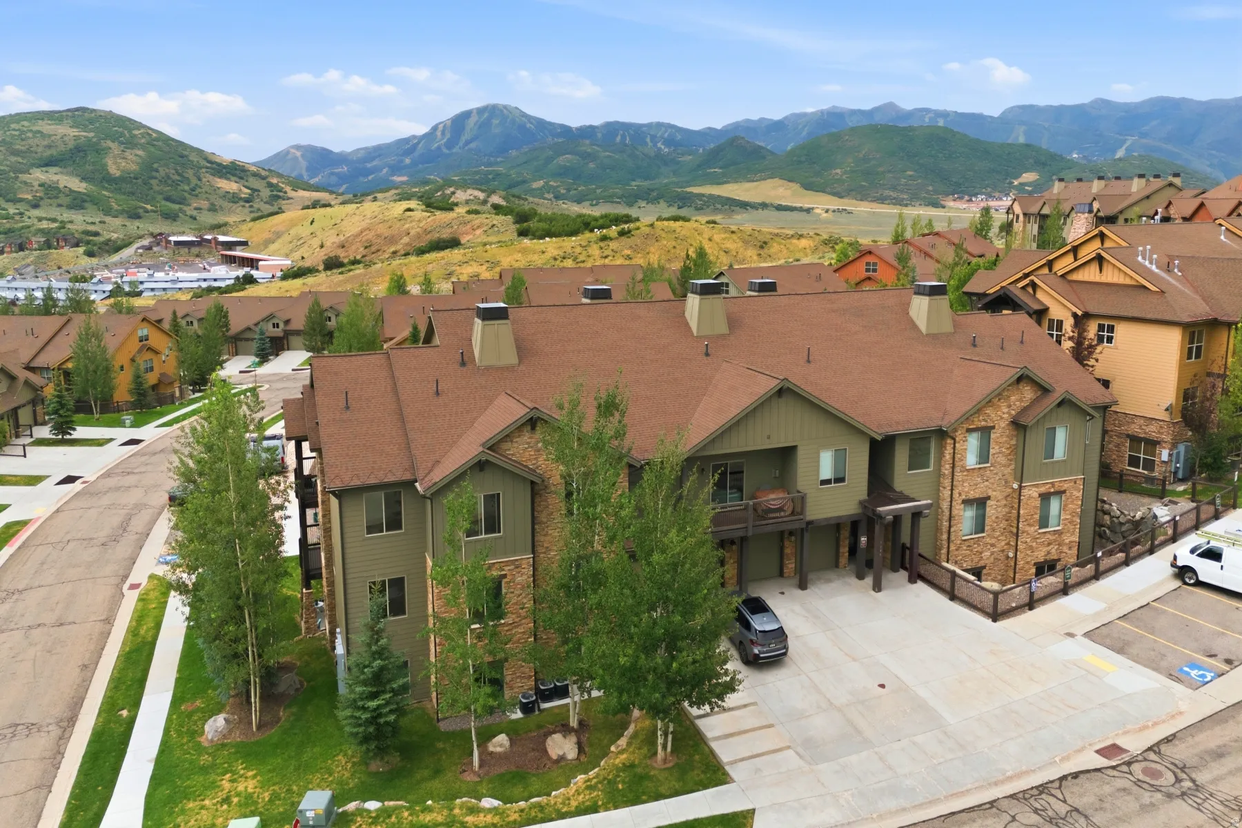 Mountain-inspired architecture featuring a multi-level design with a prominent brown roof