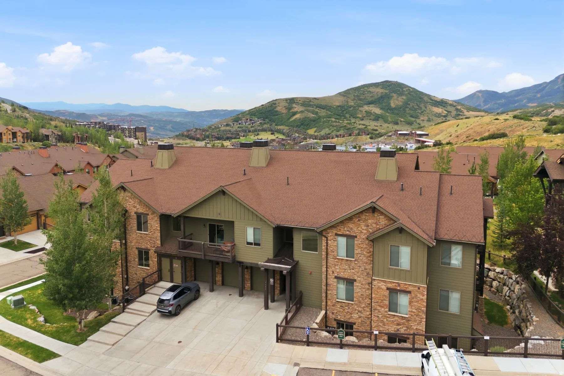 Multi-story residential structure featuring stone and siding exterior accents