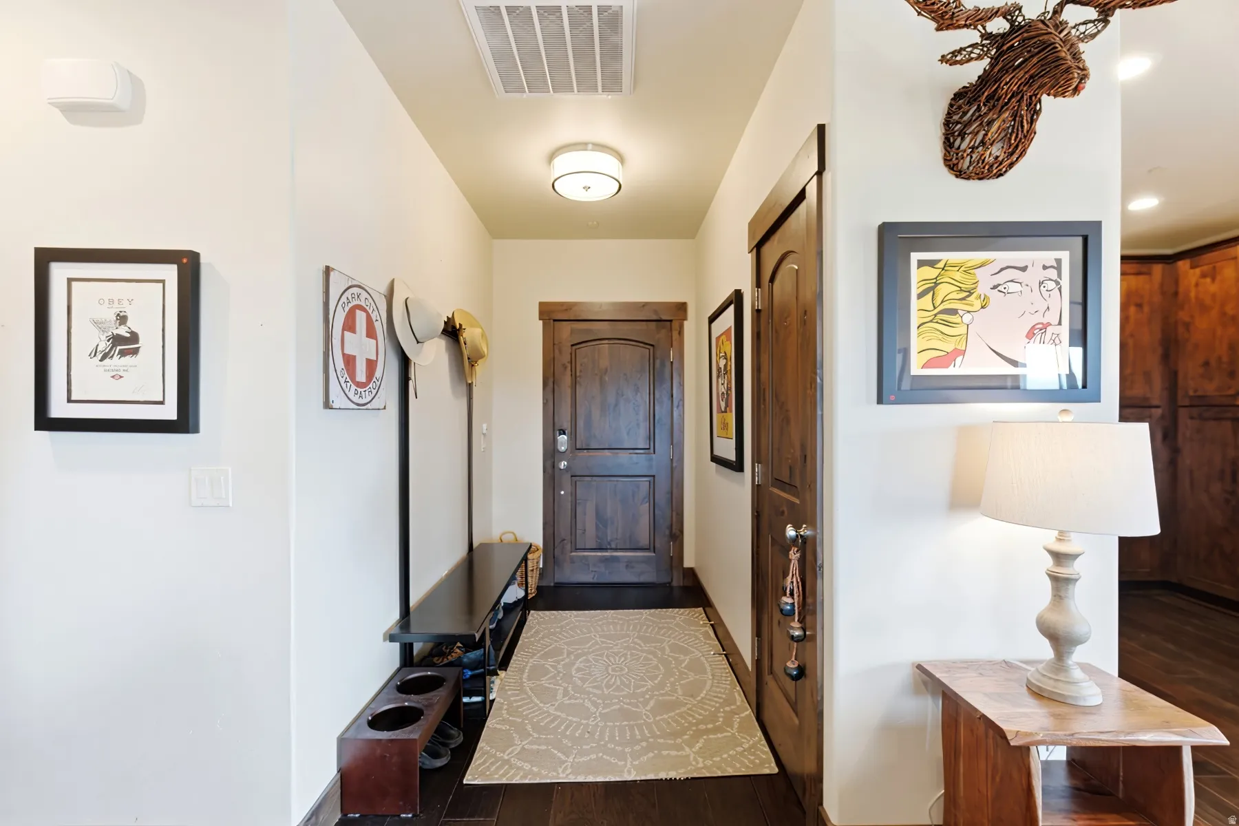 Entryway featuring a wood-panel door, dark wood-finish flooring, recessed lighting, and a contemporary ceiling fixture