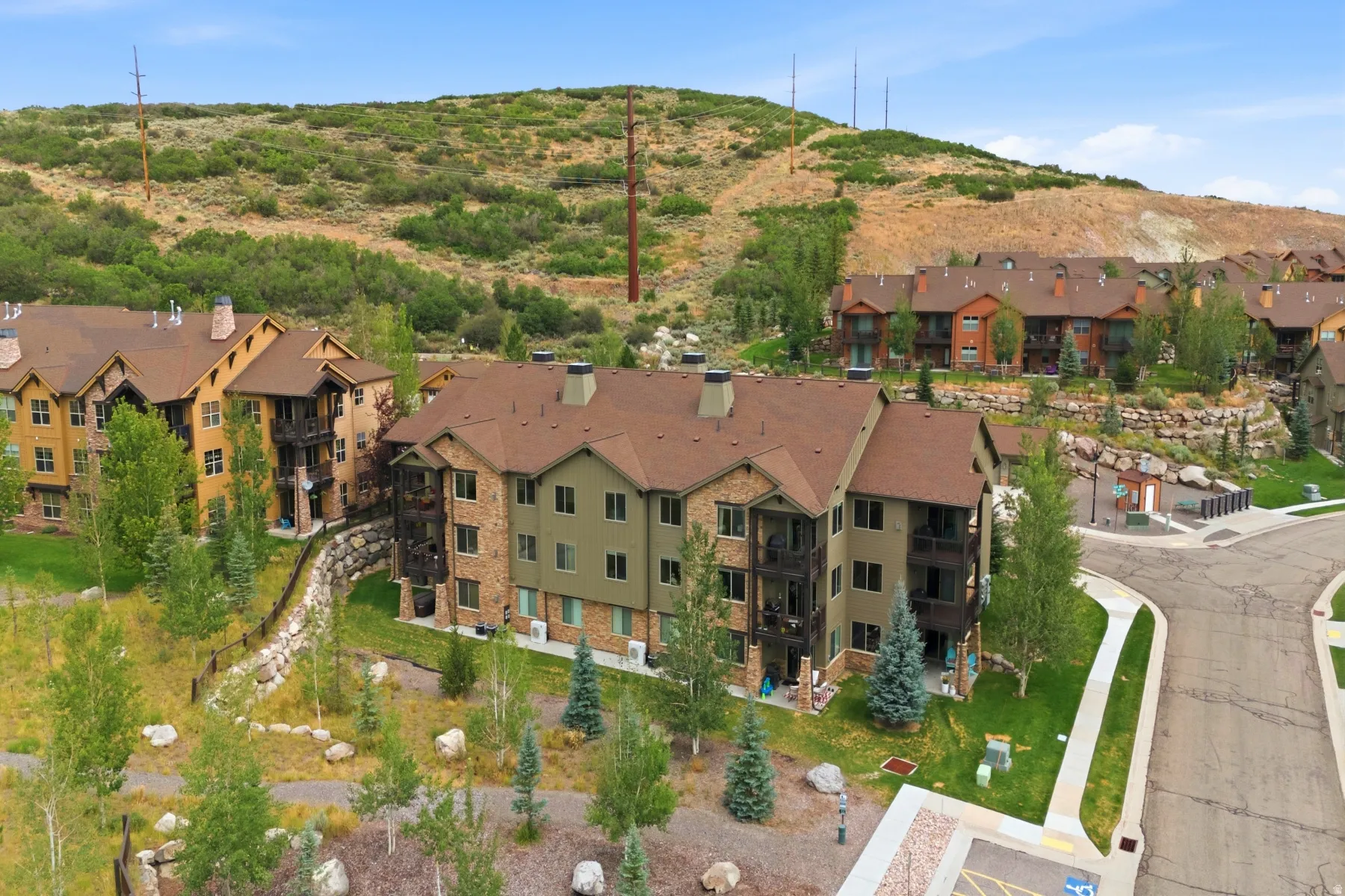 Multi-story building featuring stone and siding exterior finishes and private balconies