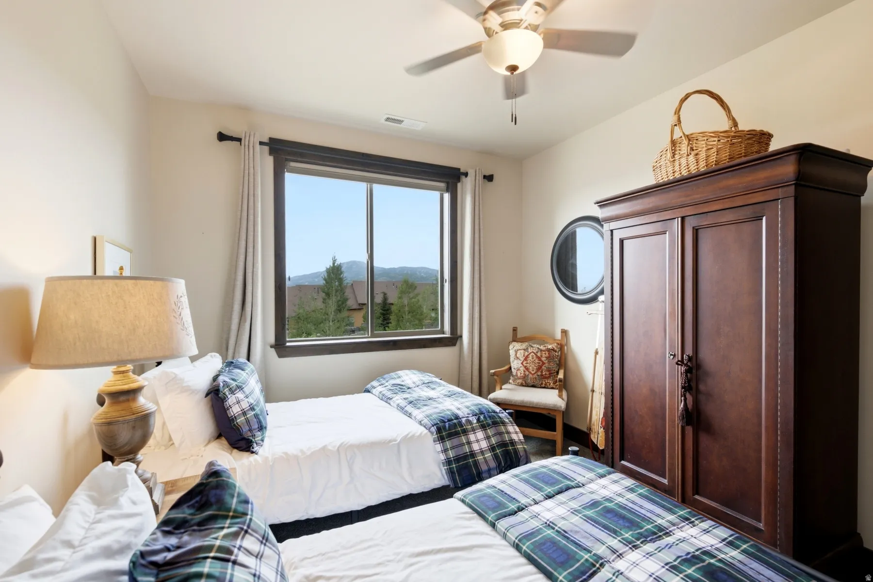 Bedroom featuring a large window, a ceiling fan with integrated lighting, and neutral wall tones