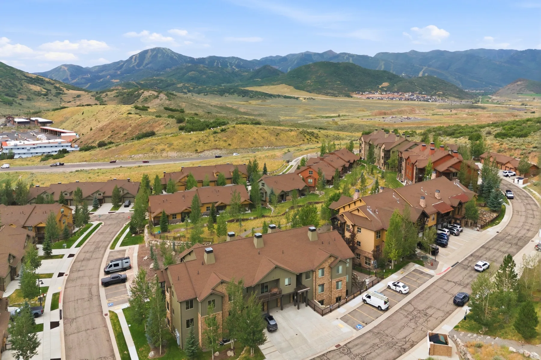 Residential community featuring multiple multi-story buildings with brown roofs and diverse exterior finishes