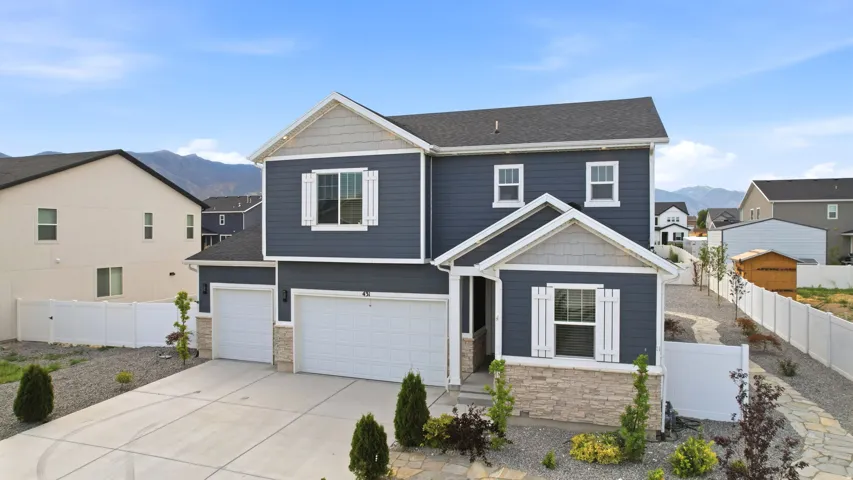 Contemporary two-story residence with a dark blue siding facade and white window shutters