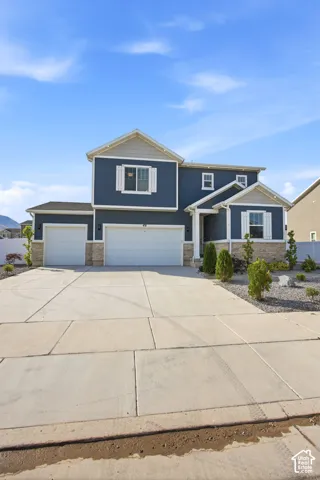 Contemporary two-story residence featuring deep blue siding and white trim accents