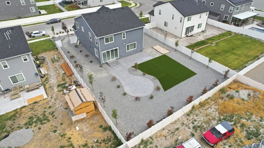 Contemporary two-story residence featuring a dark gray exterior, white trim, and a dark gray shingle roof