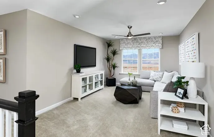 Carpeted upstairs bonus room featuring a ceiling fan, recessed lighting, and two windows with landscape scenery