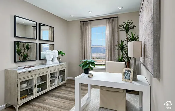 Dedicated room featuring wood-finish flooring, recessed lighting, and a window with exterior visibility