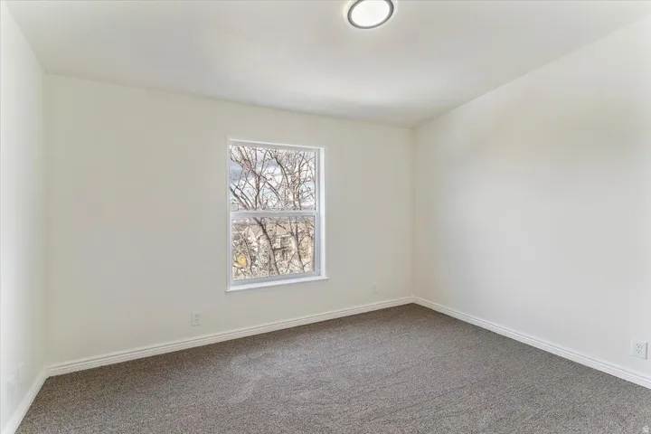 Neutral wall colors with white trim and a single window