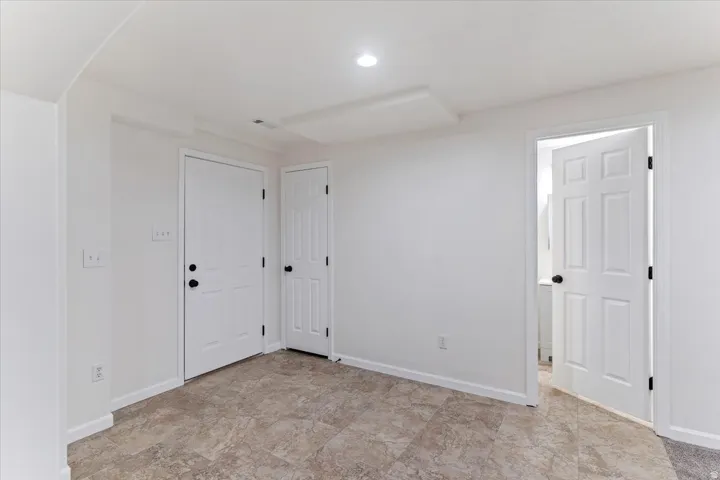 Room featuring tiled flooring, white painted walls, and recessed lighting