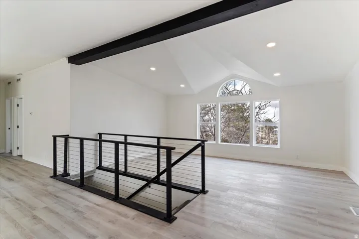 Vaulted ceiling with an exposed beam and recessed lighting