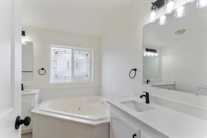 Corner soaking tub with a decorative privacy window