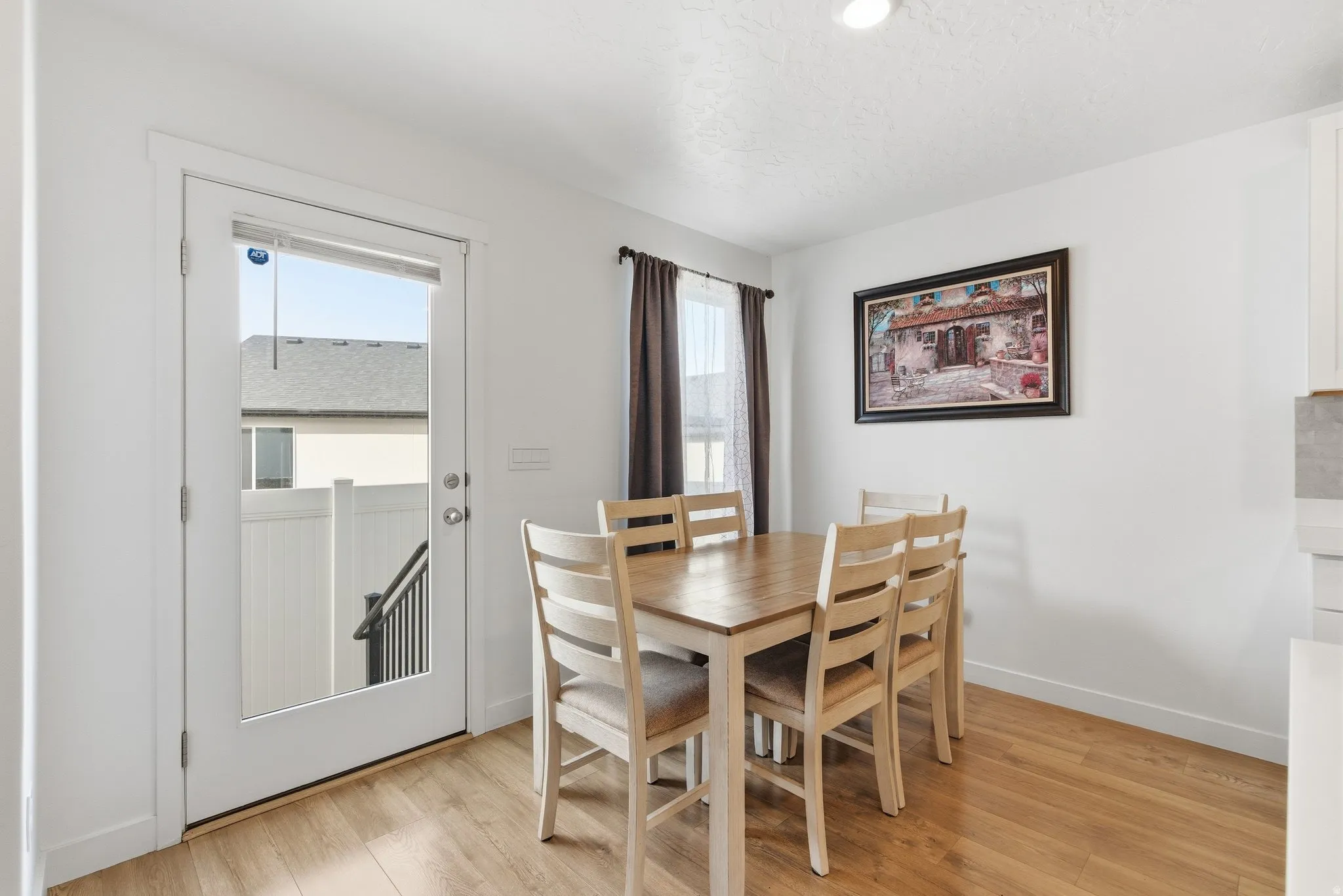 Dining area featuring wood-finish flooring and a full-light patio door with exterior access