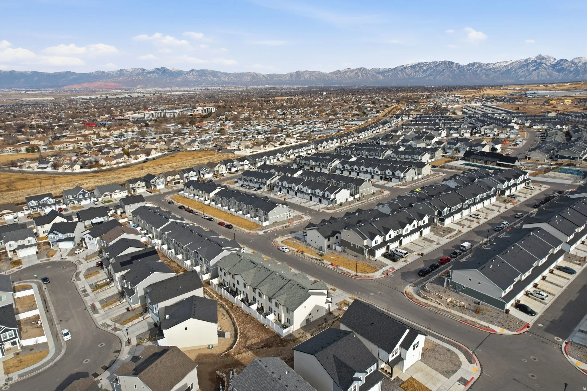 Aerial perspective showcasing a sprawling residential development with varied housing styles