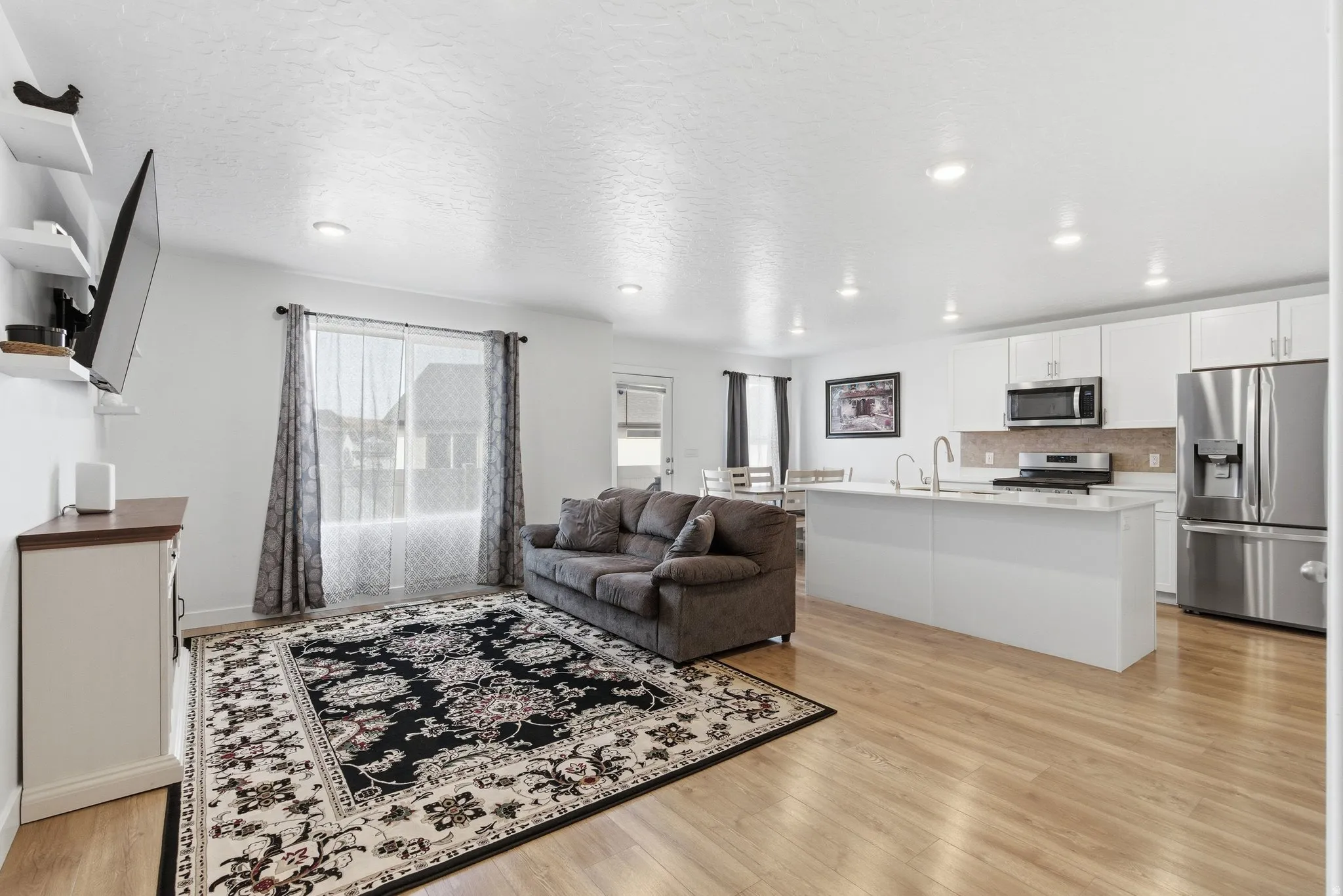 Open-concept living area featuring light wood-finish flooring throughout