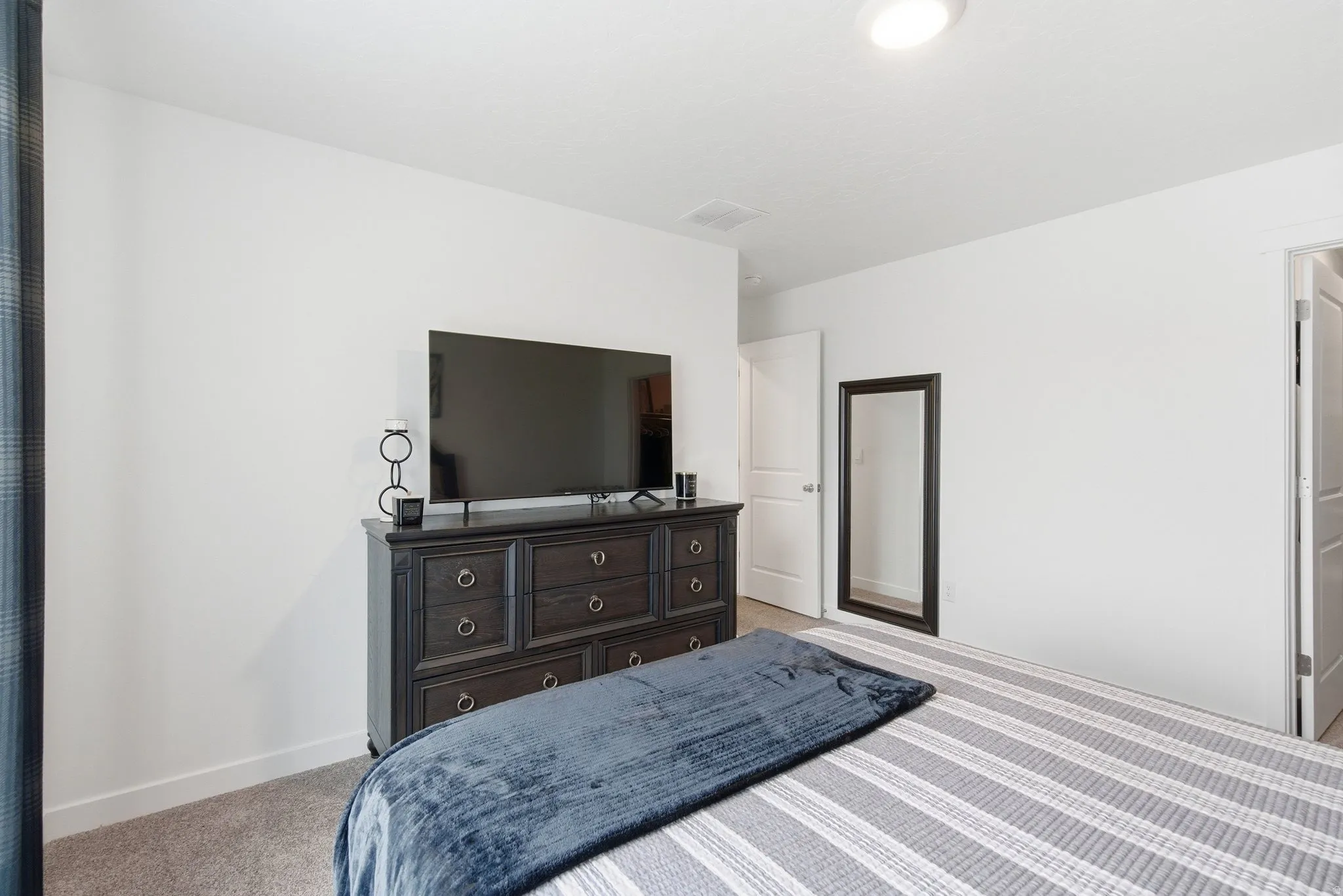 White walls and neutral carpeting provide a bright interior