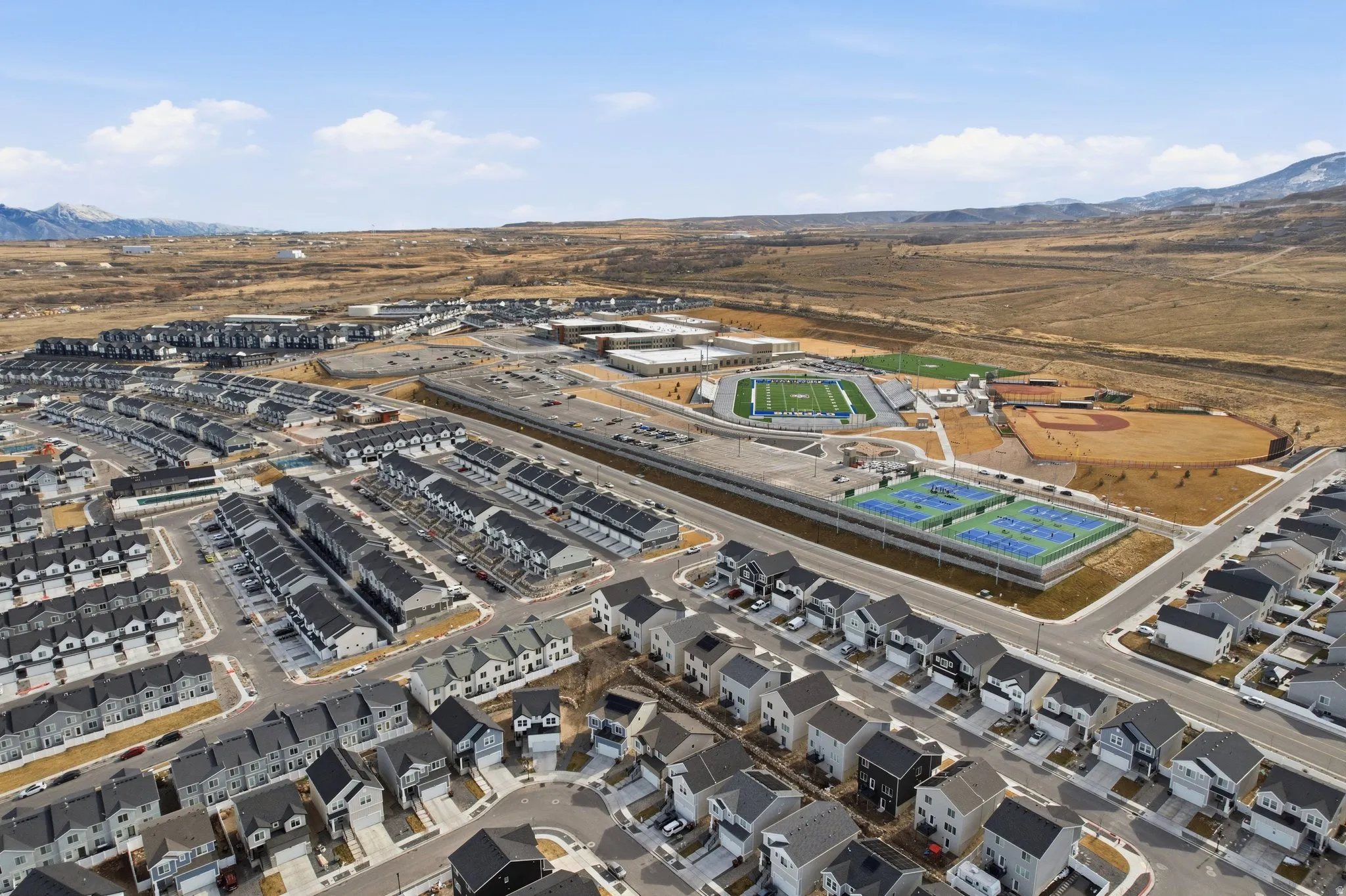 Aerial depiction of a residential community featuring rows of modern homes