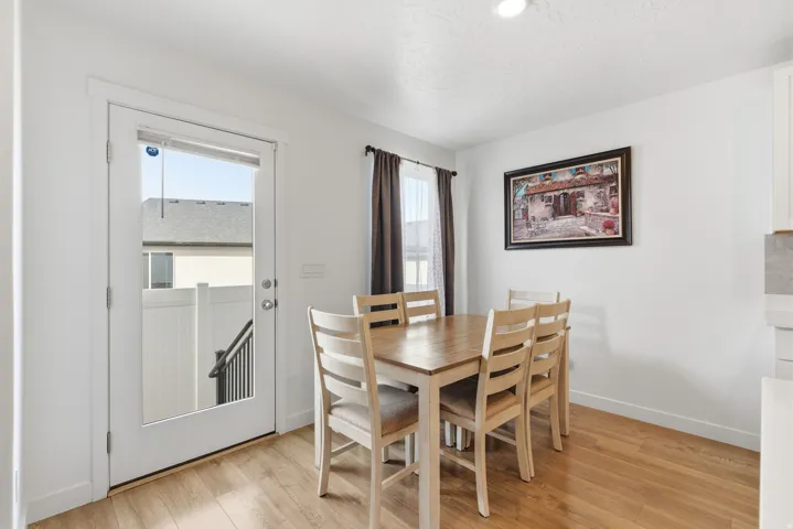 Dining area featuring wood-finish flooring and a full-light patio door with exterior access