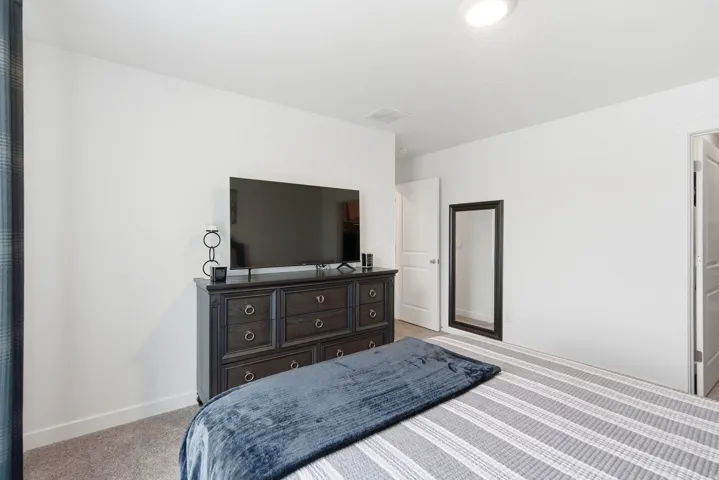 White walls and neutral carpeting provide a bright interior